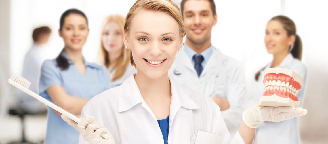 Fusion Dental Care (raleigh, Nc) Dental Team With Model Of Teeth